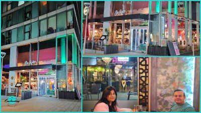 A collage of images showing the modern glass exterior of De Roka restaurant at night. The multi-story building features floor-to-ceiling windows illuminated with vibrant magenta and emerald green accent lighting on the structural columns and upper ceilings. The entrance is marked by a minimalist black canopy with a white neon "De Roka" script logo. Outdoor features include dark-slatted wooden planters with lush greenery, silver bollard lights, and views of a warm, inviting interior with crystal chandeliers.