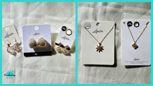 
Gemini said
A two-panel collage showcasing a selection of gold-toned jewelry from Lovisa. The left panel features three pairs of earrings on white backing cards: a pair of teardrop-shaped dangles, textured gold-toned studs, and sparkling crystal studs. The right panel shows two delicate gold necklaces on white backing cards, one featuring a sunburst pendant and the other a small, square-shaped pendant.