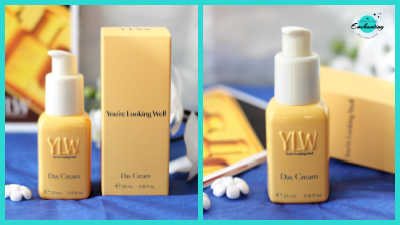 Minimalist YLW (You're Looking Well) skincare set featuring buttery-yellow rectangular bottles and matching boxes of Day Cream with embossed branding and cream-colored pumps, styled next to white orchids on a vibrant deep blue background.